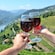 Two wine glasses raised for a toast in front of an overlook